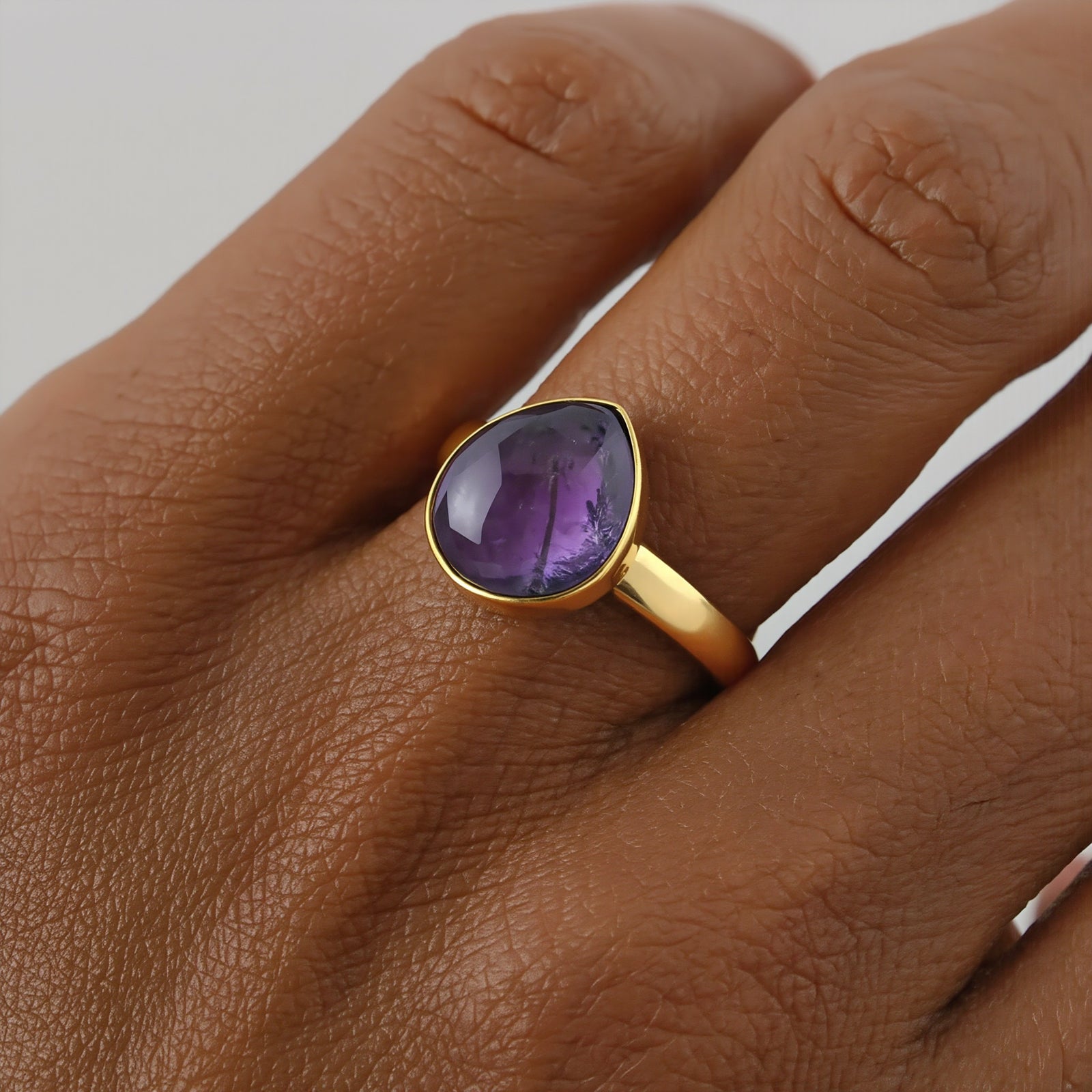 Amara Jewels 18K gold vermeil ring with a faceted deep violet amethyst gemstone in a bezel setting.