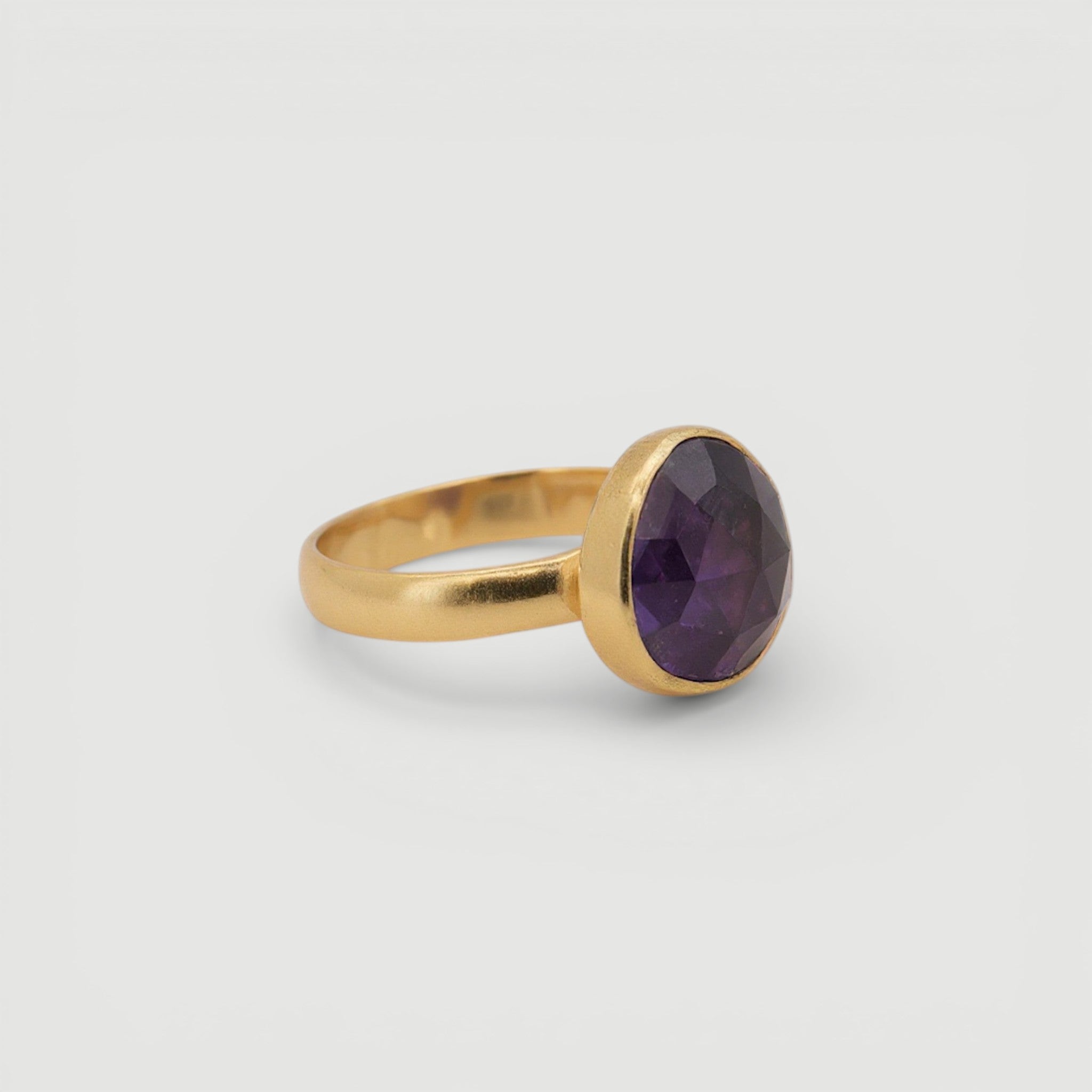 Amara Jewels 18K gold vermeil ring with a faceted deep violet amethyst gemstone in a bezel setting.