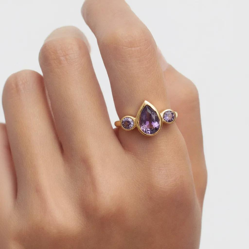 Amara Jewels gold vermeil sterling silver ring with pear-cut and round-cut amethyst gemstones.