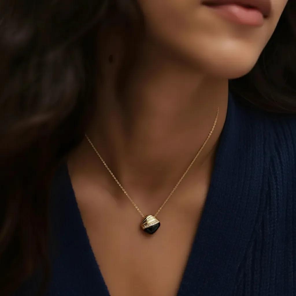 Amara Jewels gold 925 sterling silver necklace with black agate pendant, accented with crystals.