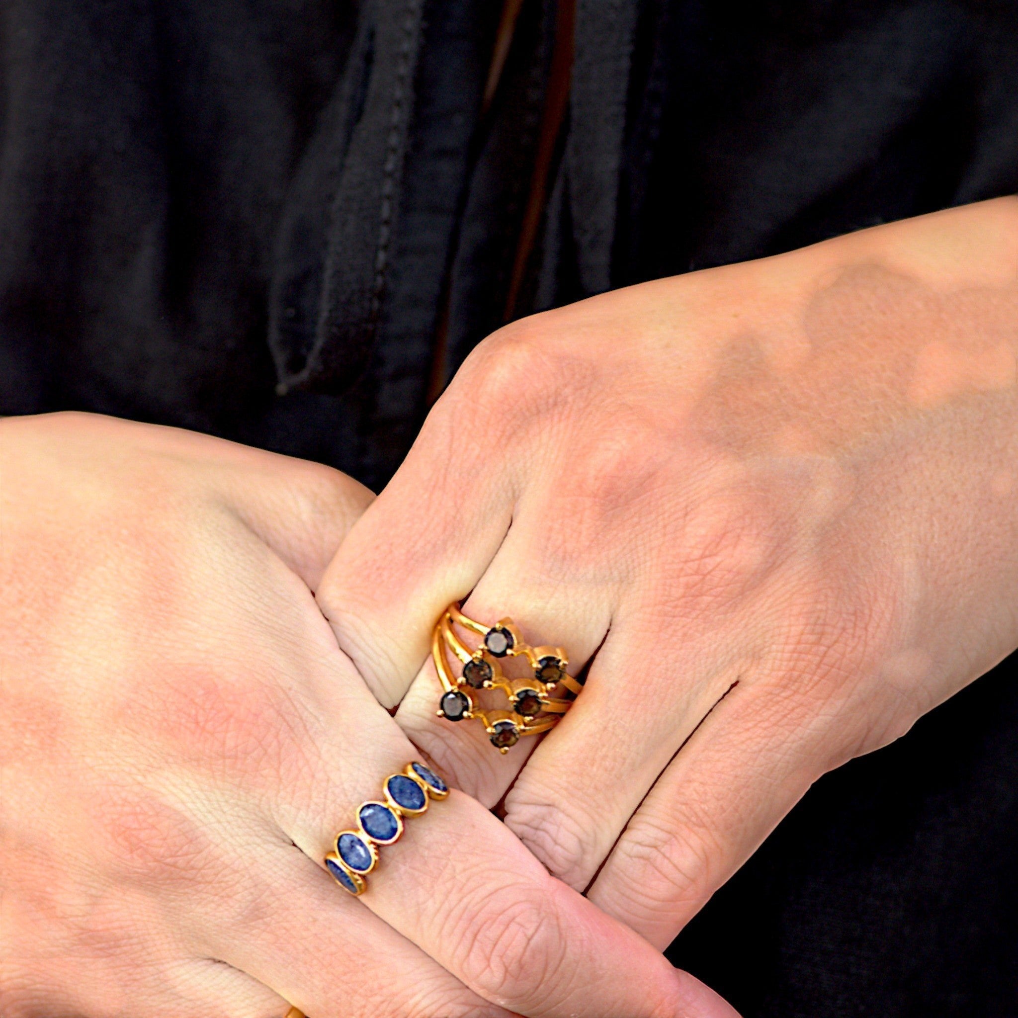 Amara Jewels gold-plated sterling silver band ring with five oval-cut blue sapphire gemstones.