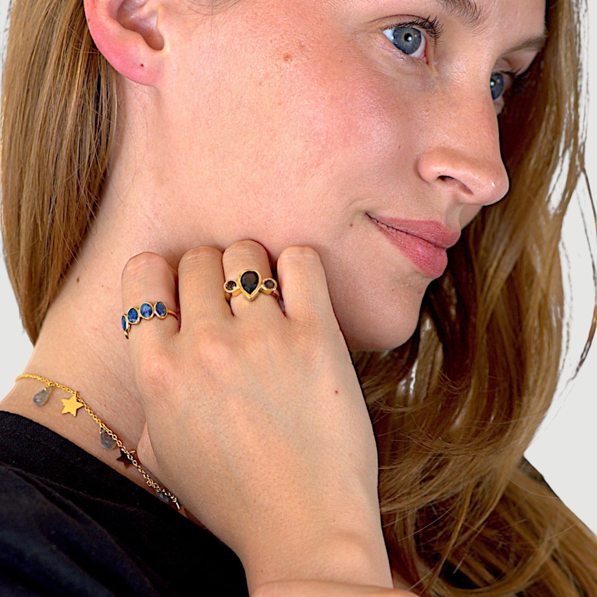 Amara Jewels gold-plated sterling silver band ring with five oval-cut blue sapphire gemstones.