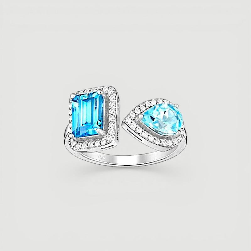Amara Jewels open ring with emerald-cut and pear-shaped blue topaz stones, accented with cubic zirconia, set in sterling silver.