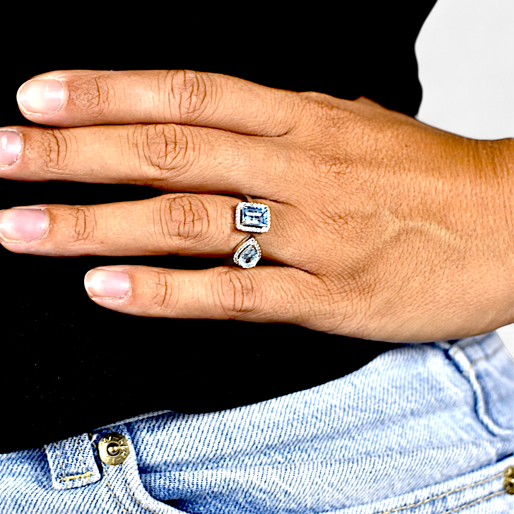 Amara Jewels open ring with emerald-cut and pear-shaped blue topaz stones, accented with cubic zirconia, set in sterling silver.