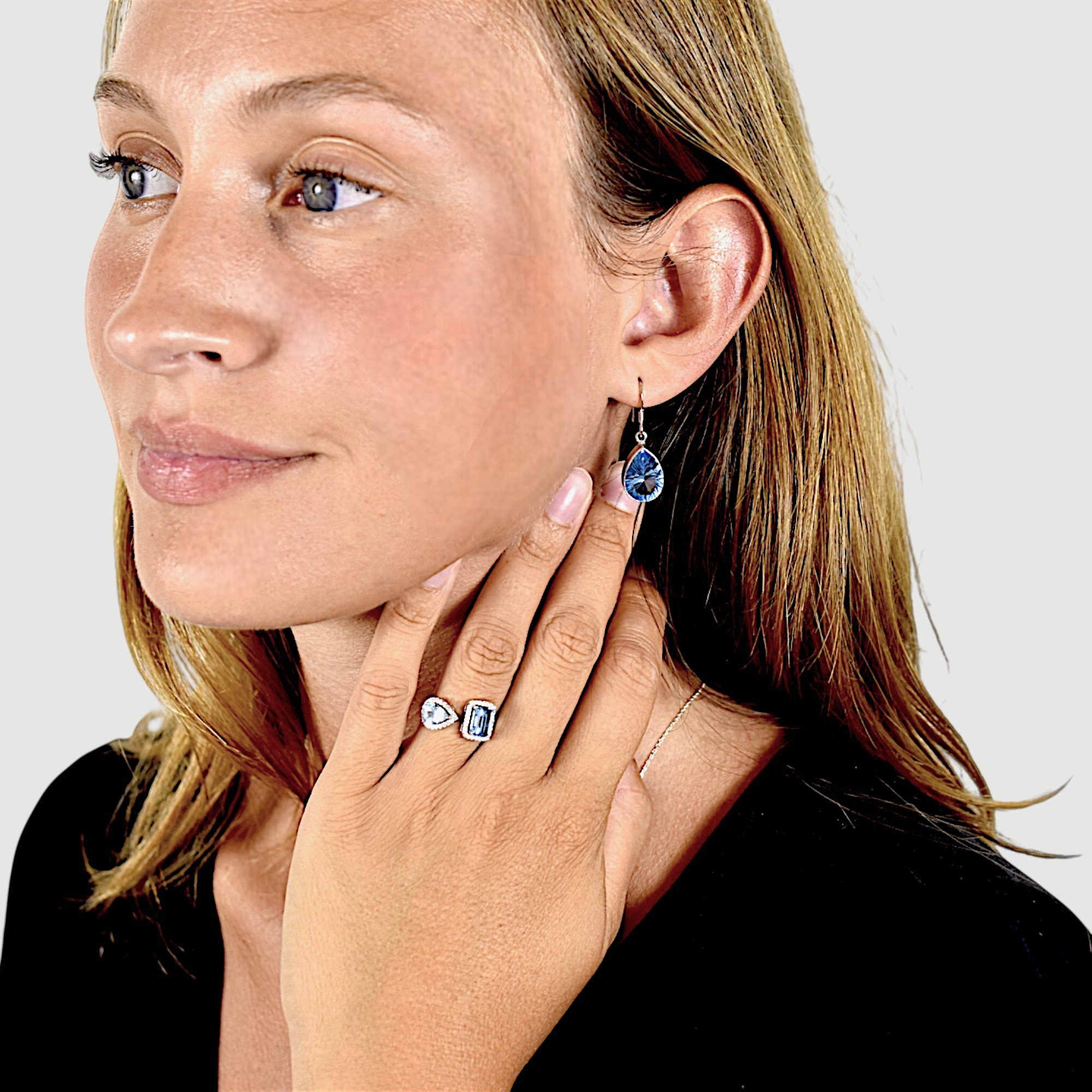 Amara Jewels open ring with emerald-cut and pear-shaped blue topaz stones, accented with cubic zirconia, set in sterling silver.
