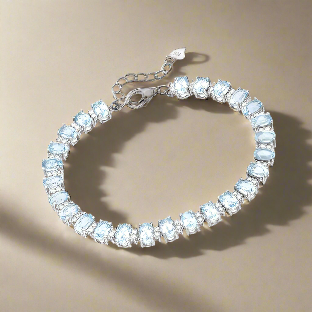 Amara Jewels blue topaz tennis bracelet in 925 sterling silver with adjustable clasp. Elegant and radiant.