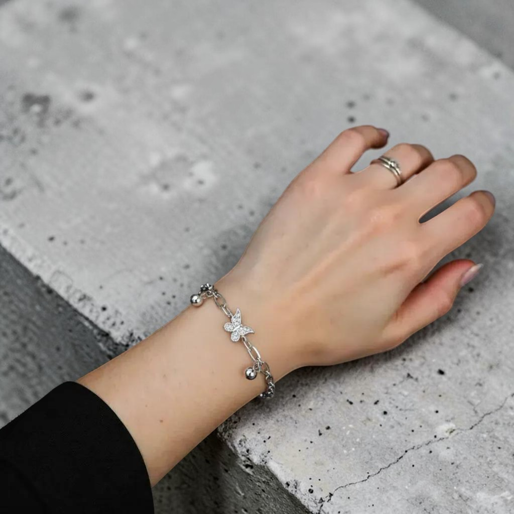 Amara Jewels sterling silver bracelet with delicate butterfly charms and polished silver beads, adjustable clasp.