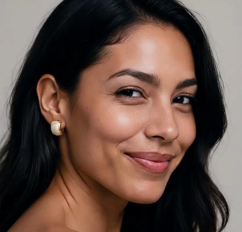 Amara Jewels champagne pearl stud earrings with textured gold plating and half-moon shape.