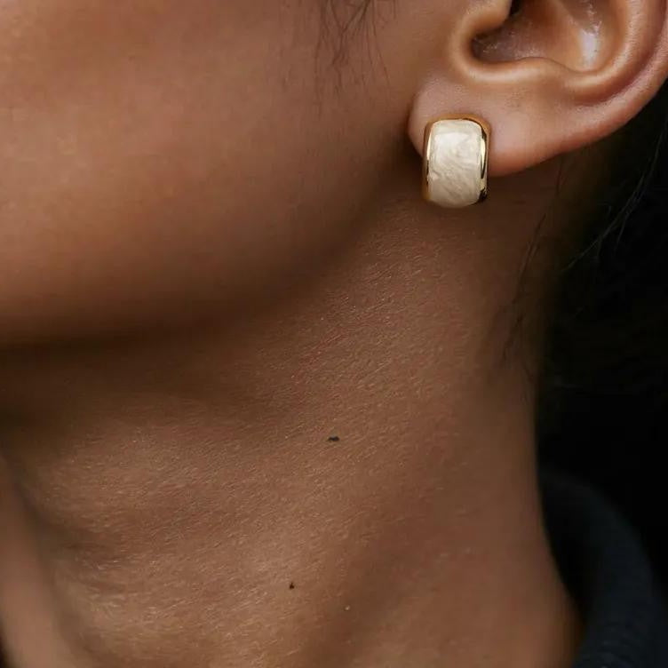 Amara Jewels champagne pearl stud earrings with textured gold plating and half-moon shape.