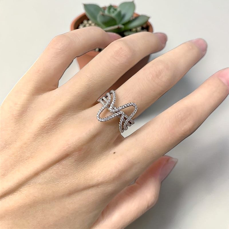 Amara Jewels sterling silver statement ring with cubic zirconia in a curved wave design.