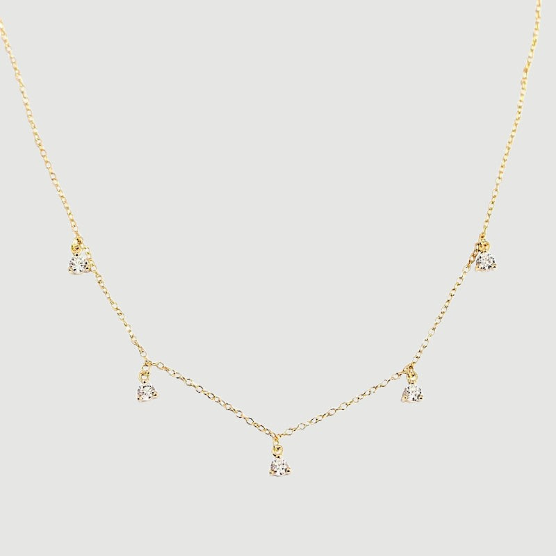 Amara Jewels gold-plated sterling silver necklace with five small crystal pendants spaced along a delicate chain.