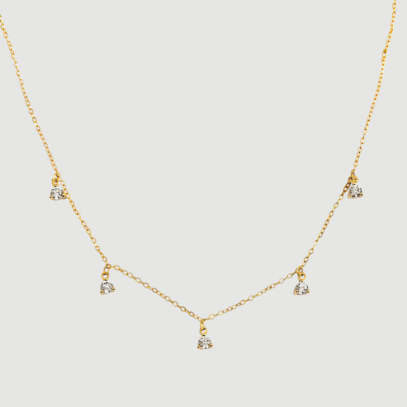 Amara Jewels gold-plated sterling silver necklace with five small crystal pendants spaced along a delicate chain.