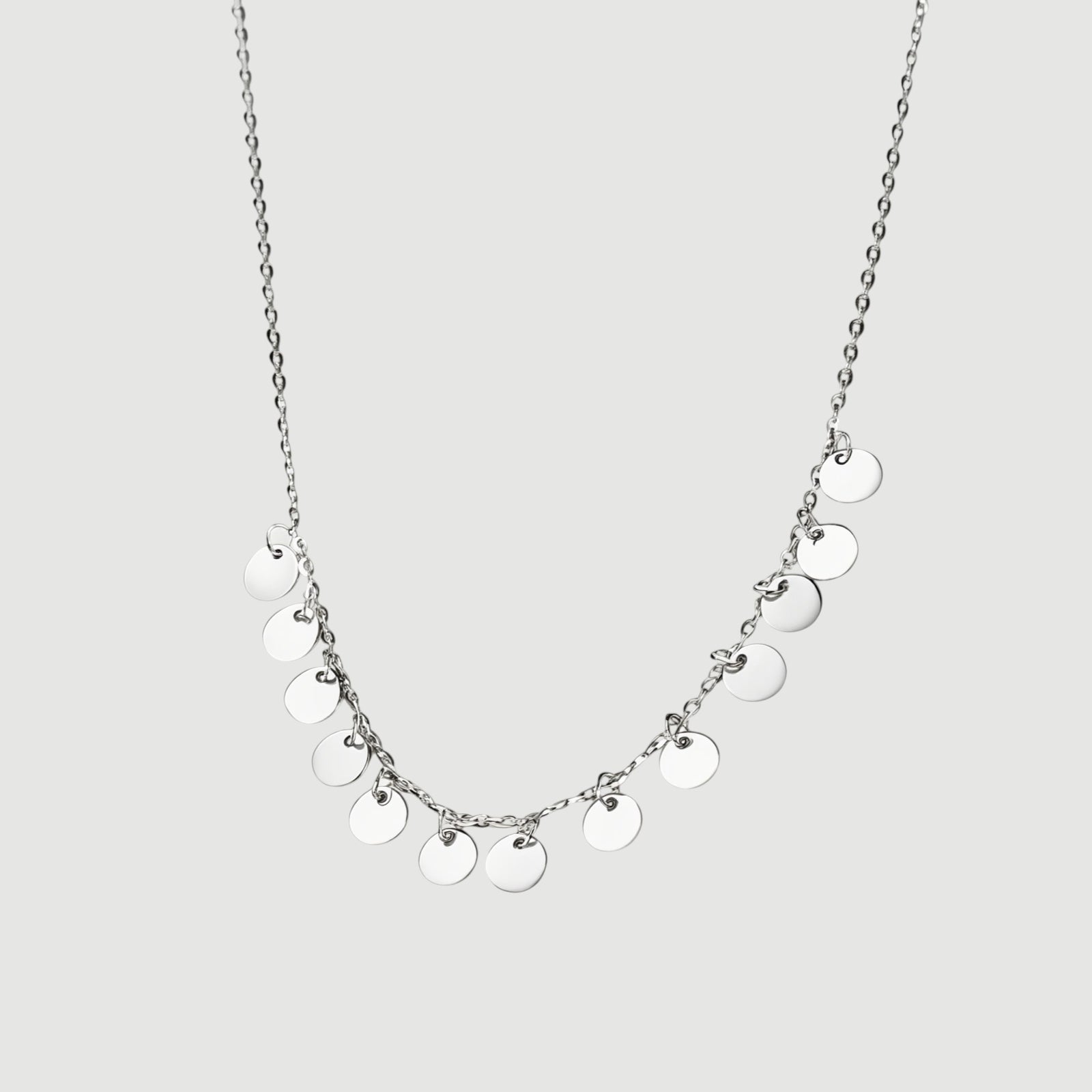 Amara Jewels delicate sterling silver necklace with multiple small disc charms, perfect for everyday wear.