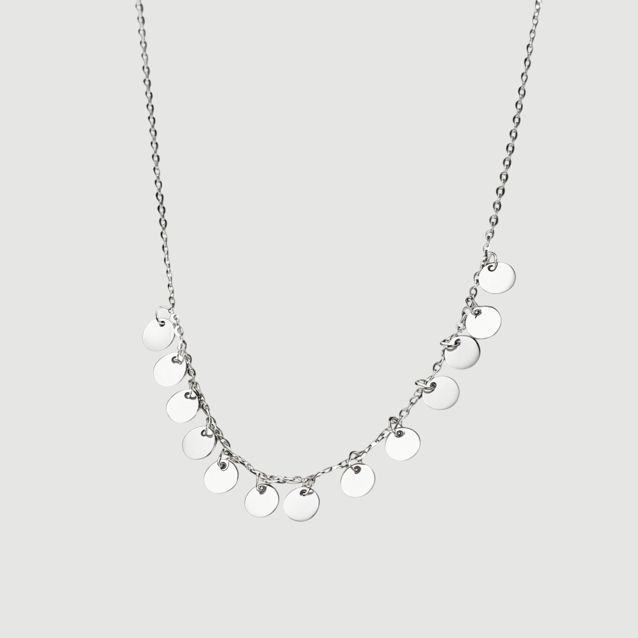 Amara Jewels delicate sterling silver necklace with multiple small disc charms, perfect for everyday wear.