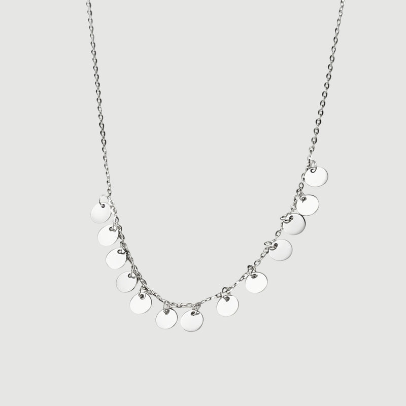 Amara Jewels delicate sterling silver necklace with multiple small disc charms, perfect for everyday wear.