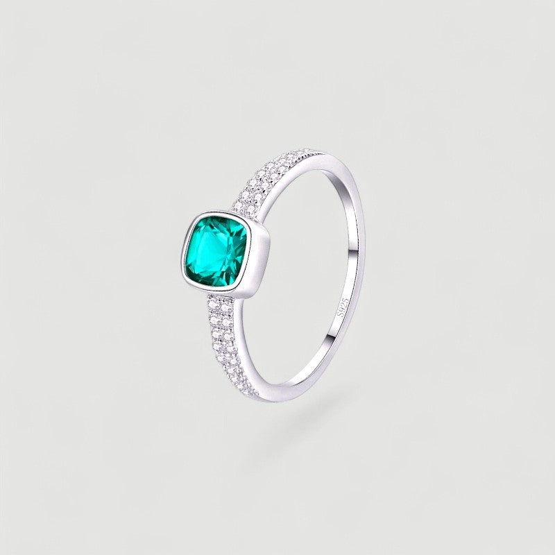 Amara Jewels sterling silver ring with cushion-cut emerald green stone and pave-set crystals.