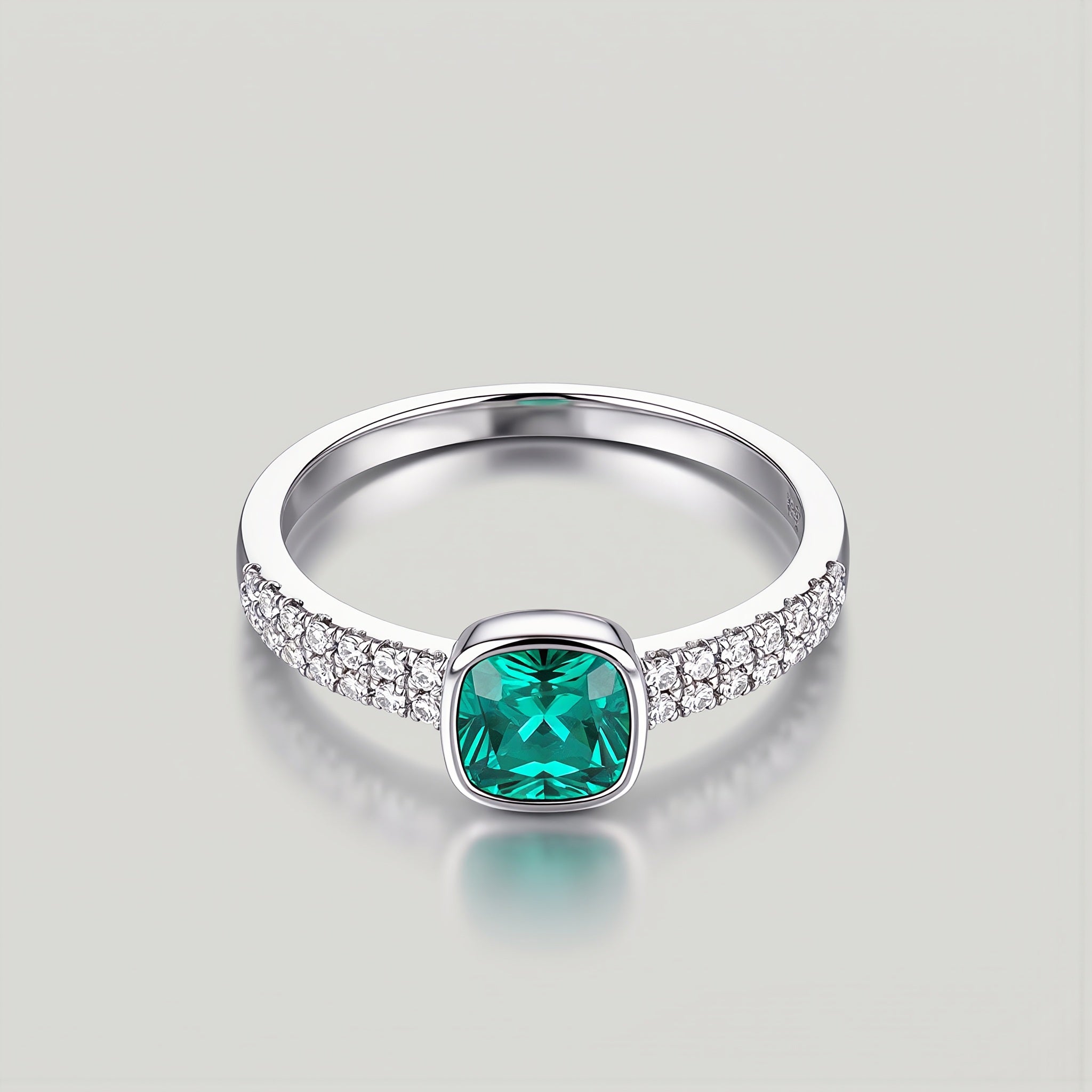 Amara Jewels sterling silver ring with cushion-cut emerald green stone and pave-set crystals.