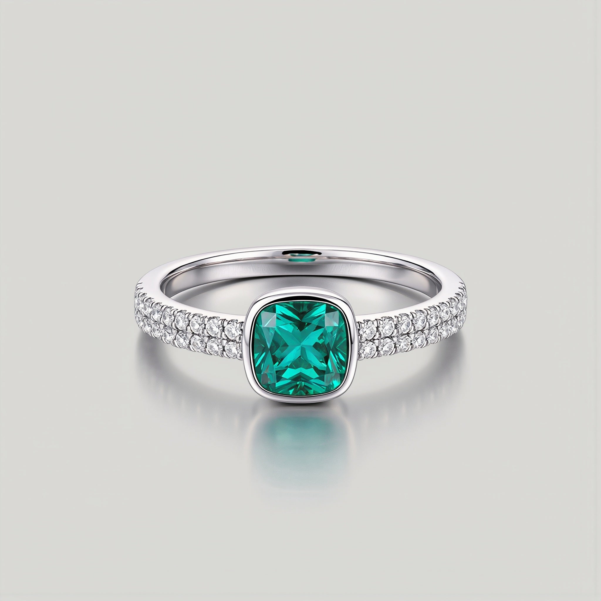 Amara Jewels sterling silver ring with cushion-cut emerald green stone and pave-set crystals.