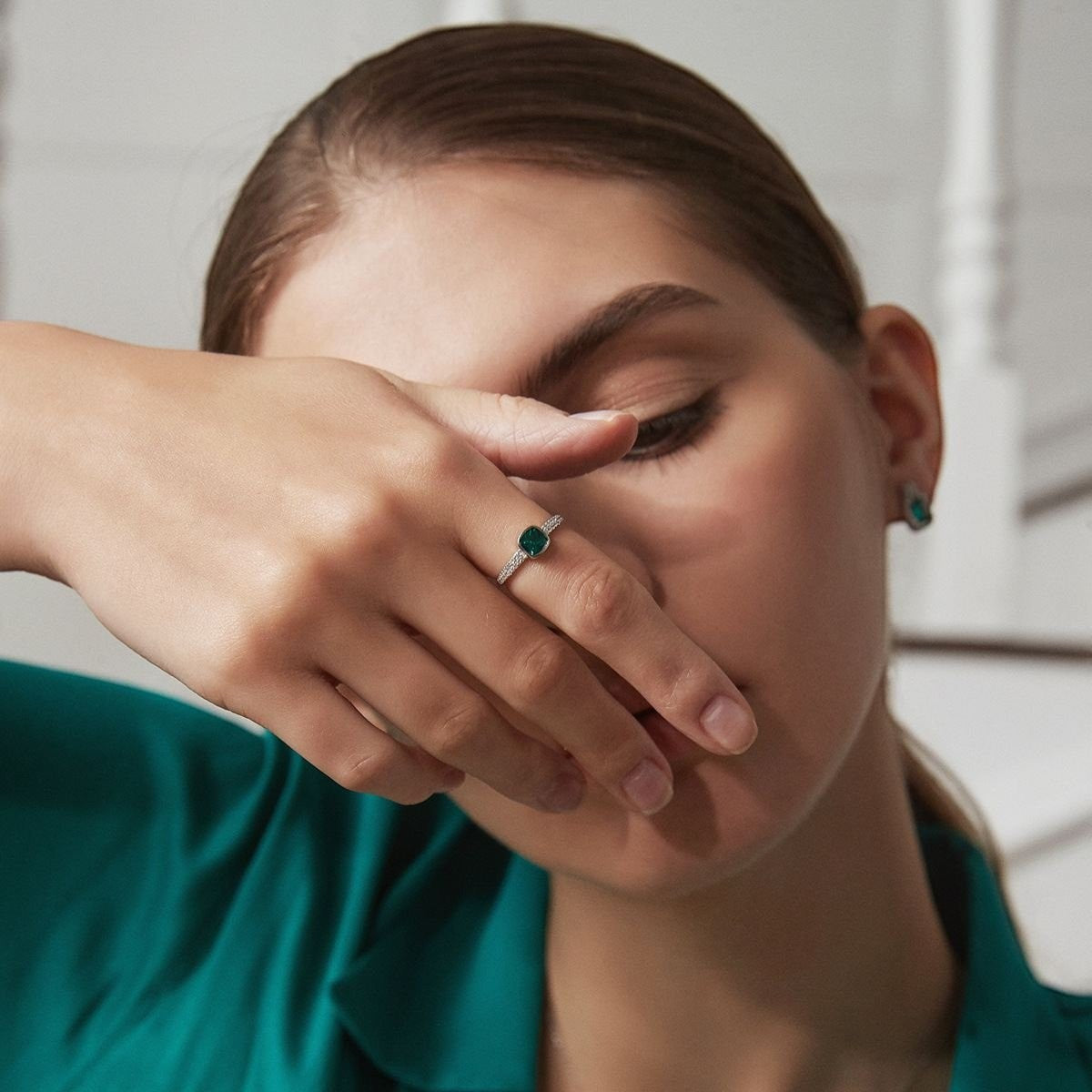 Amara Jewels sterling silver ring with cushion-cut emerald green stone and pave-set crystals.