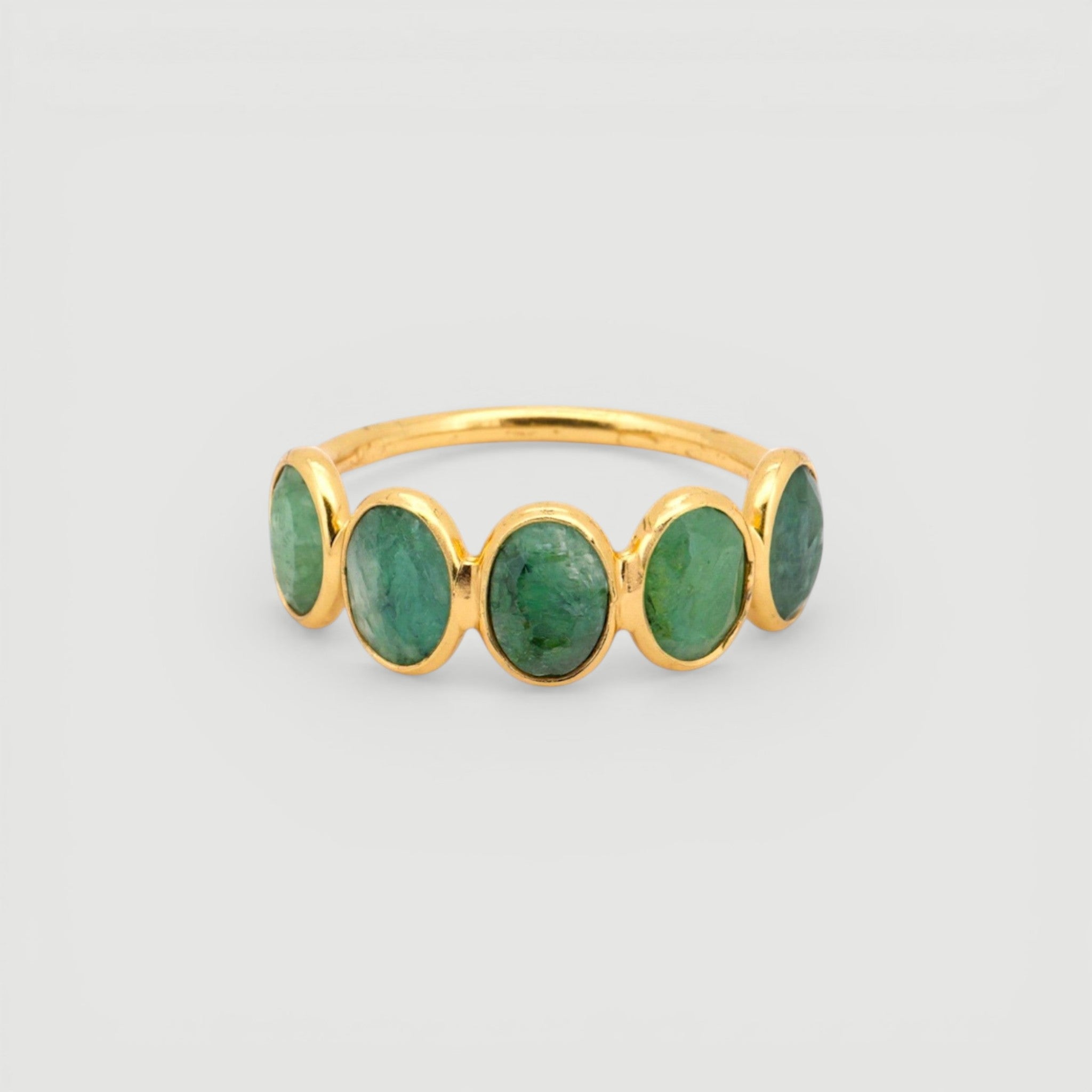 Amara Jewels 18K gold vermeil ring with five oval-cut emeralds set in sterling silver.