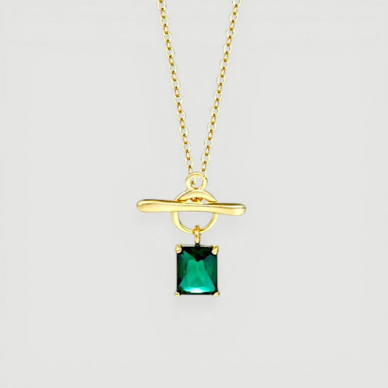 Amara Jewels gold vermeil sterling silver necklace with a rectangular emerald-green gemstone and toggle clasp.