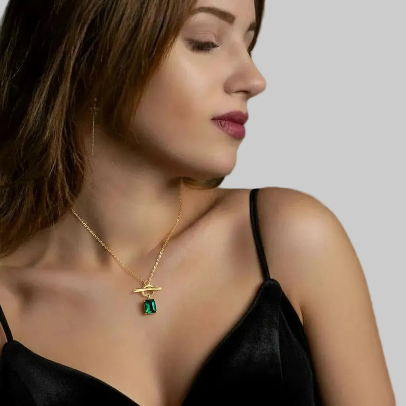 Amara Jewels gold vermeil sterling silver necklace with a rectangular emerald-green gemstone and toggle clasp.