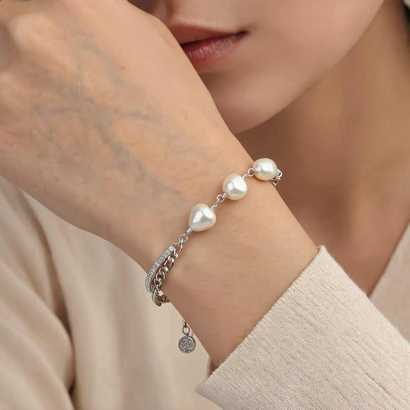 Amara Jewels 925 sterling silver bracelet with freshwater pearls and a dual chain design, one chain is accented with sparkling stones.
