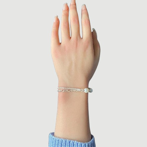 Amara Jewels 925 sterling silver bracelet with freshwater pearls and a dual chain design, one chain is accented with sparkling stones.