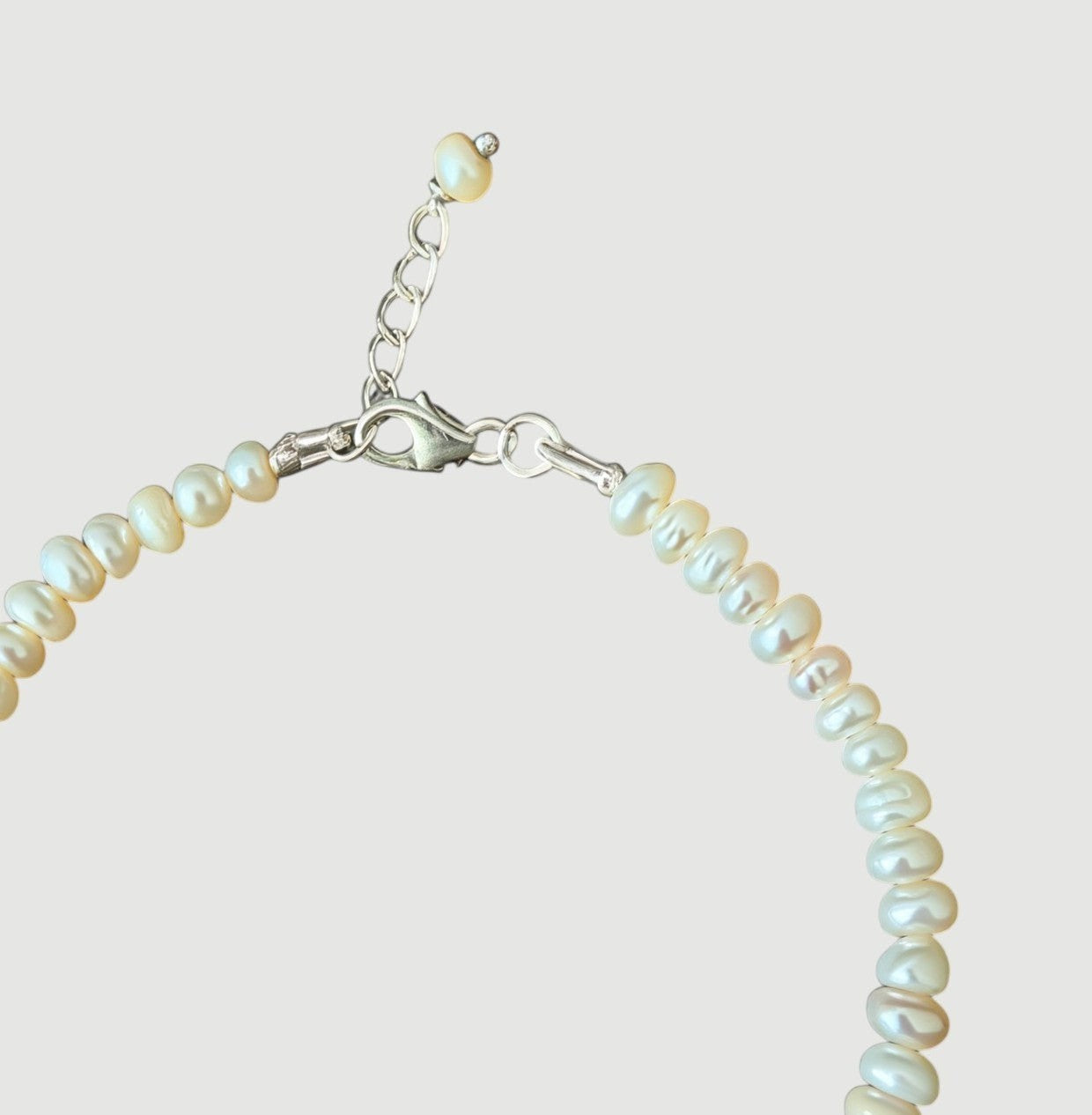 Amara Jewels Freshwater Pearl Bracelet with silver clasp and adjustable chain. White pearls with natural luster.