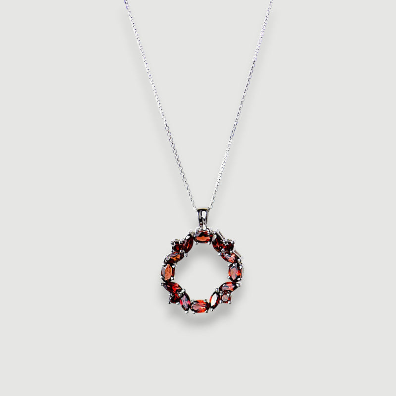 Amara Jewels sterling silver necklace with a wreath pendant featuring deep red natural garnet gemstones.