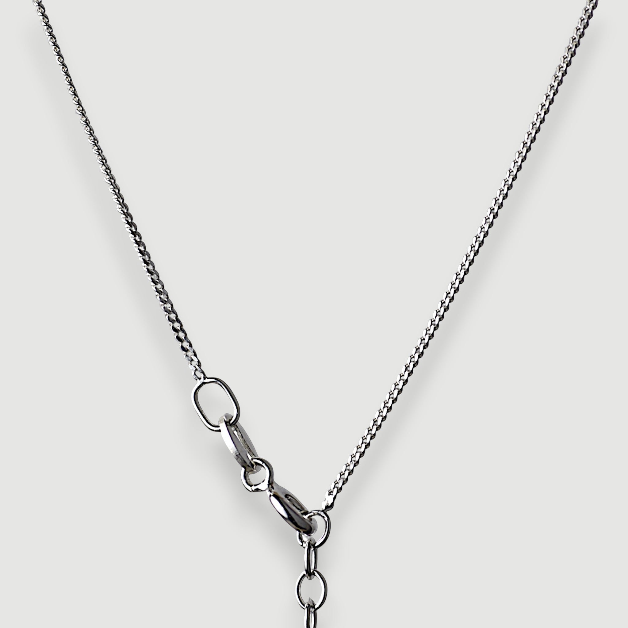 Amara Jewels sterling silver necklace with a wreath pendant featuring deep red natural garnet gemstones.