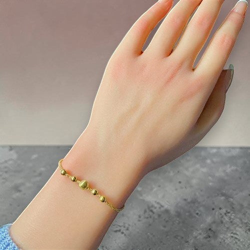 Amara Jewels gold-plated sterling silver bracelet with delicate chain and polished, textured beads.