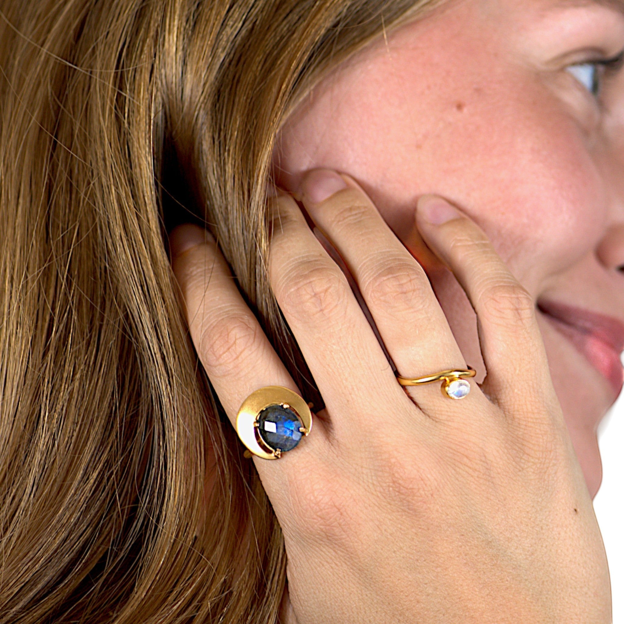 Amara Jewels gold ring with a dark grey gemstone in a crescent bezel on a 925 sterling silver band with 18k gold vermeil.