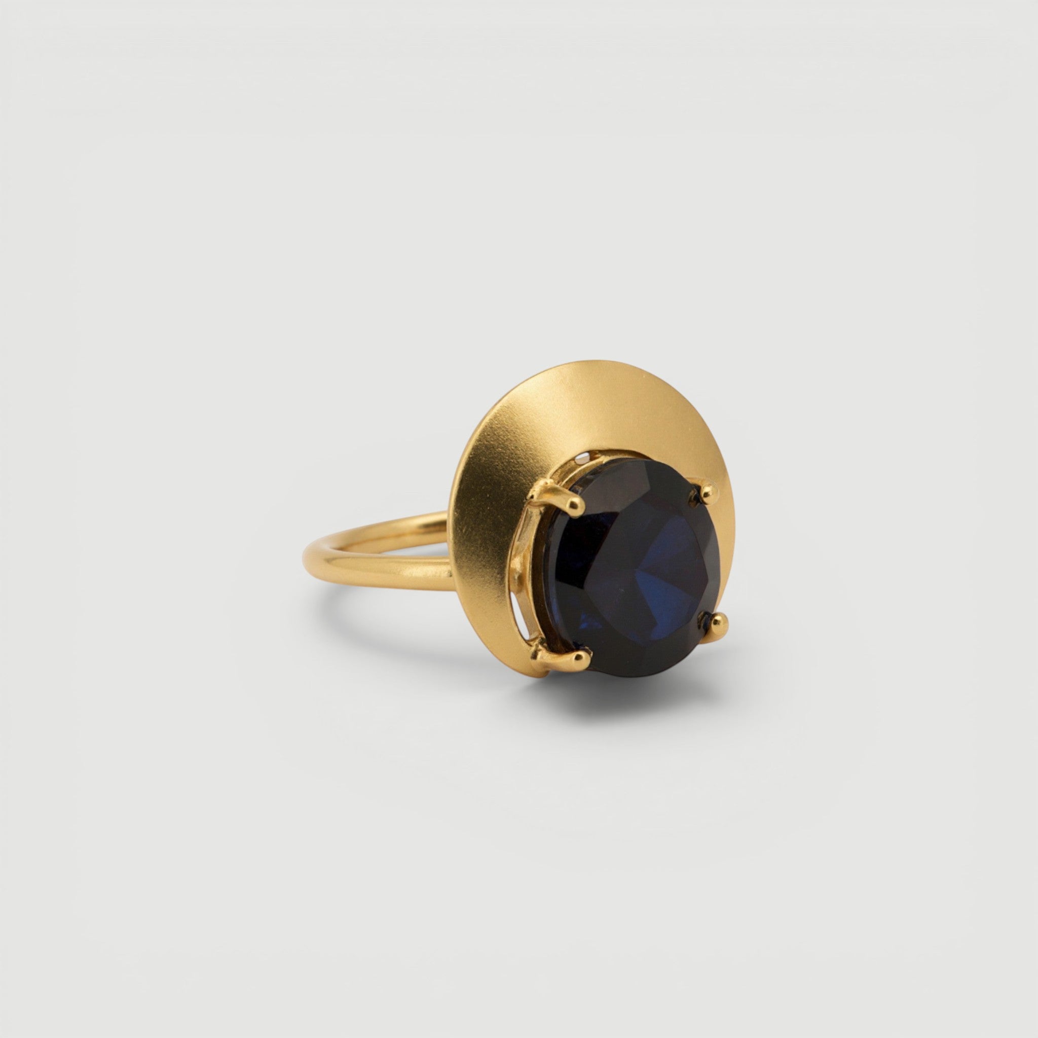 Amara Jewels gold ring with a dark grey gemstone in a crescent bezel on a 925 sterling silver band with 18k gold vermeil.