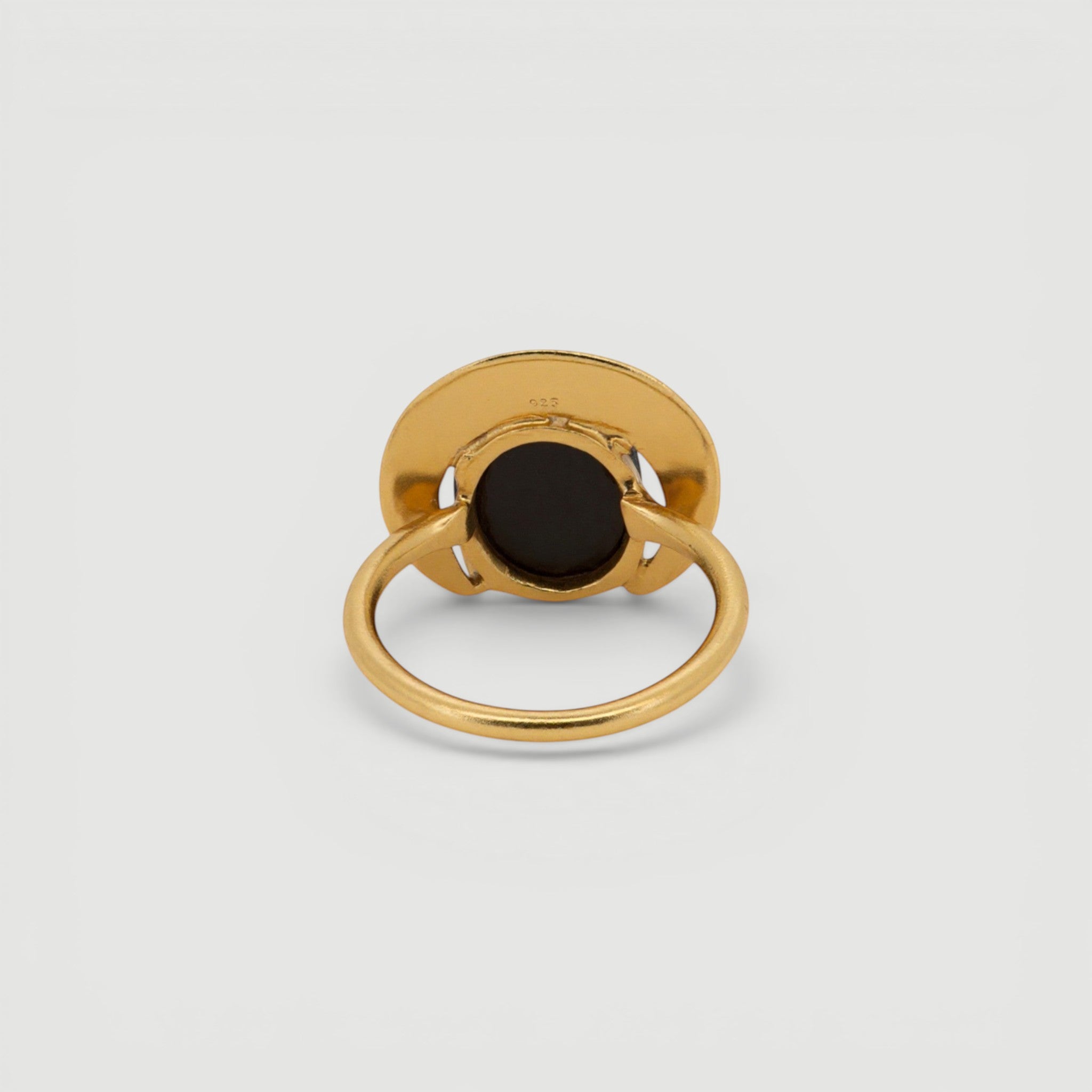 Amara Jewels gold ring with a dark grey gemstone in a crescent bezel on a 925 sterling silver band with 18k gold vermeil.