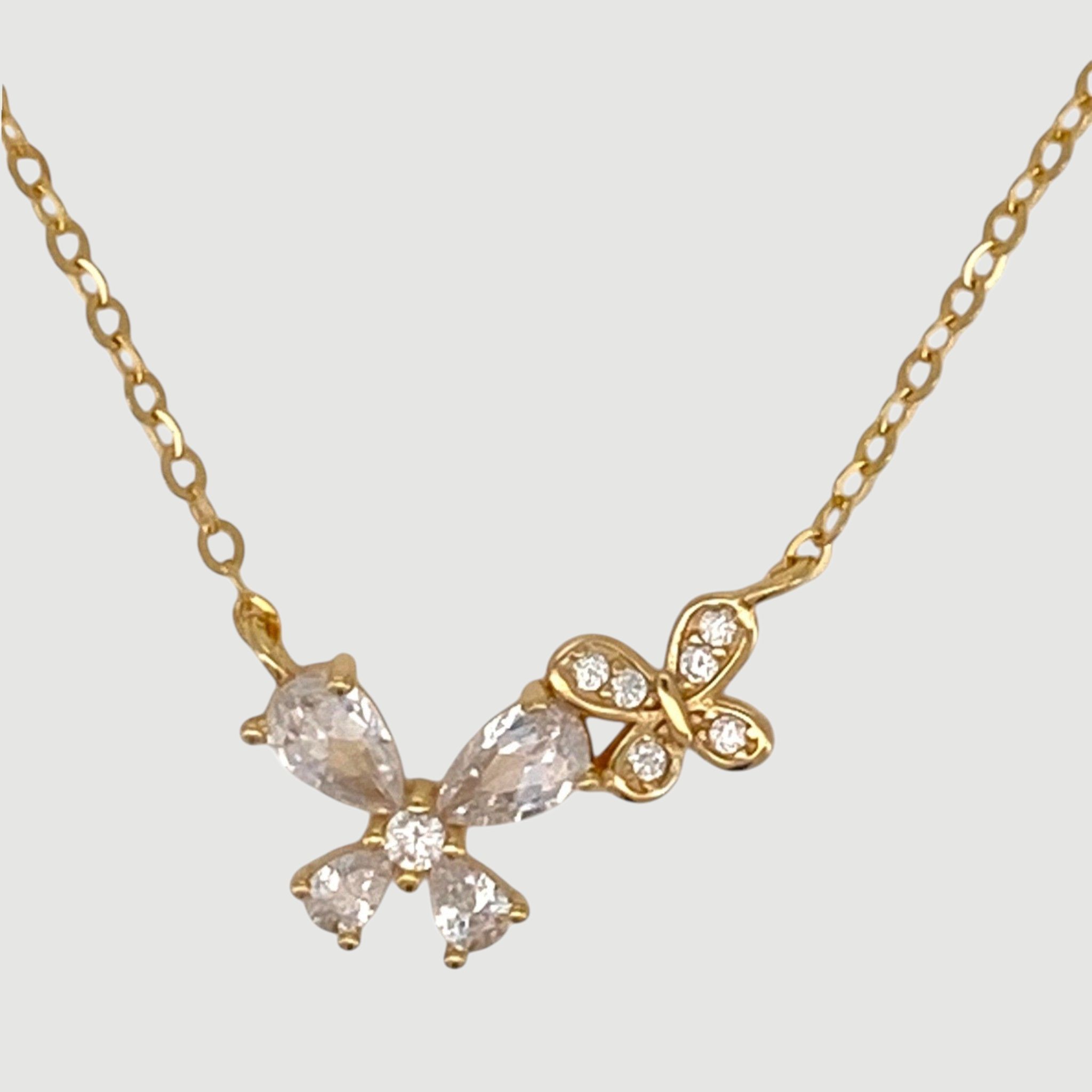 Amara Jewels gold-tone sterling silver necklace with cubic zirconia butterfly and floral accents.