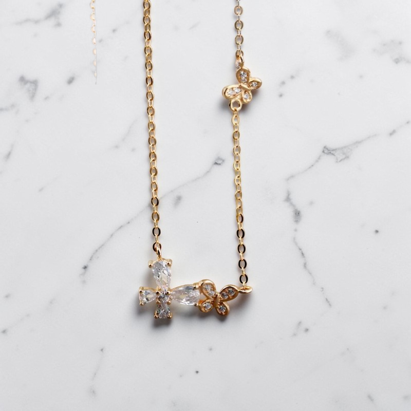 Amara Jewels gold-tone sterling silver necklace with cubic zirconia butterfly and floral accents.