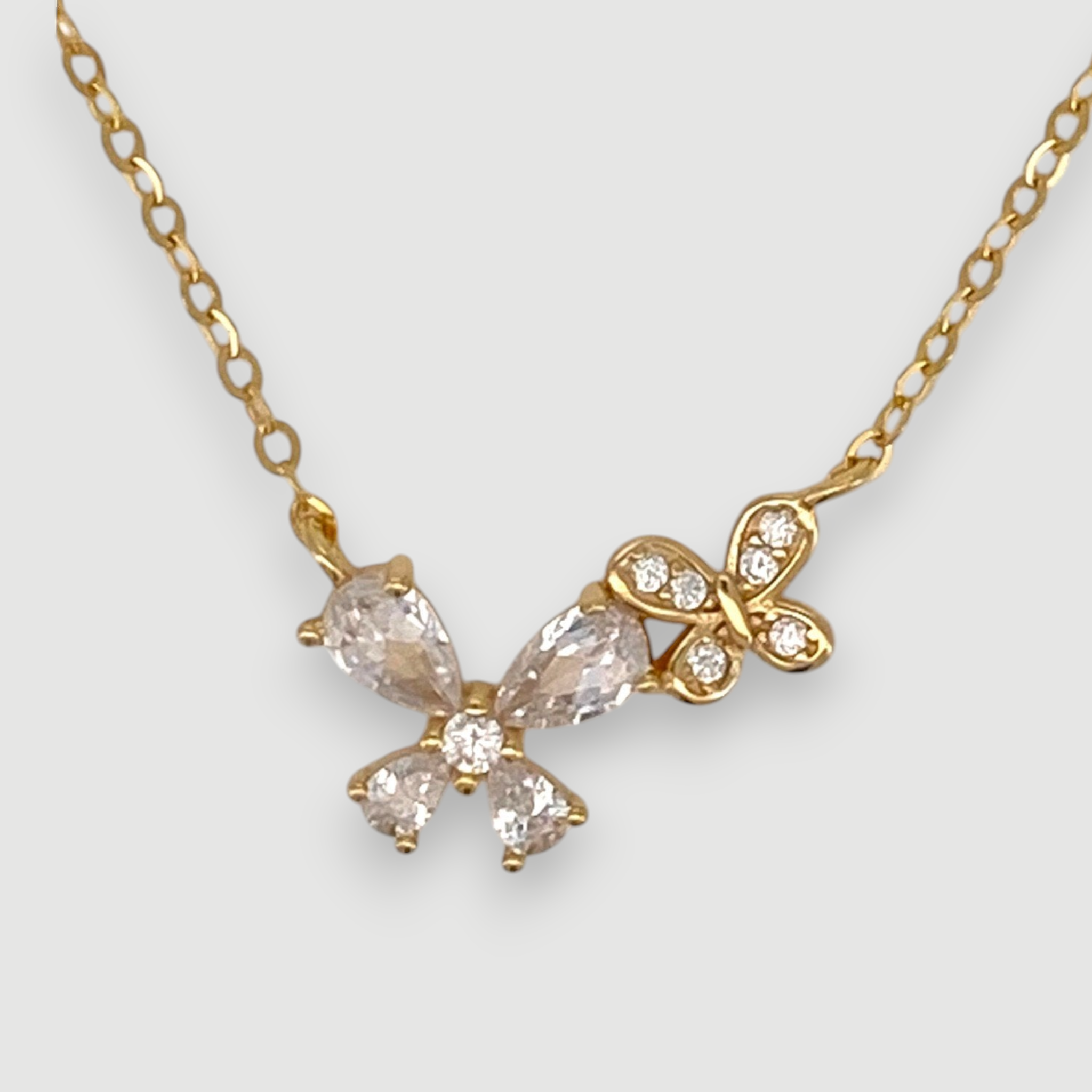 Amara Jewels gold-tone sterling silver necklace with butterfly and floral design, accented with cubic zirconia.