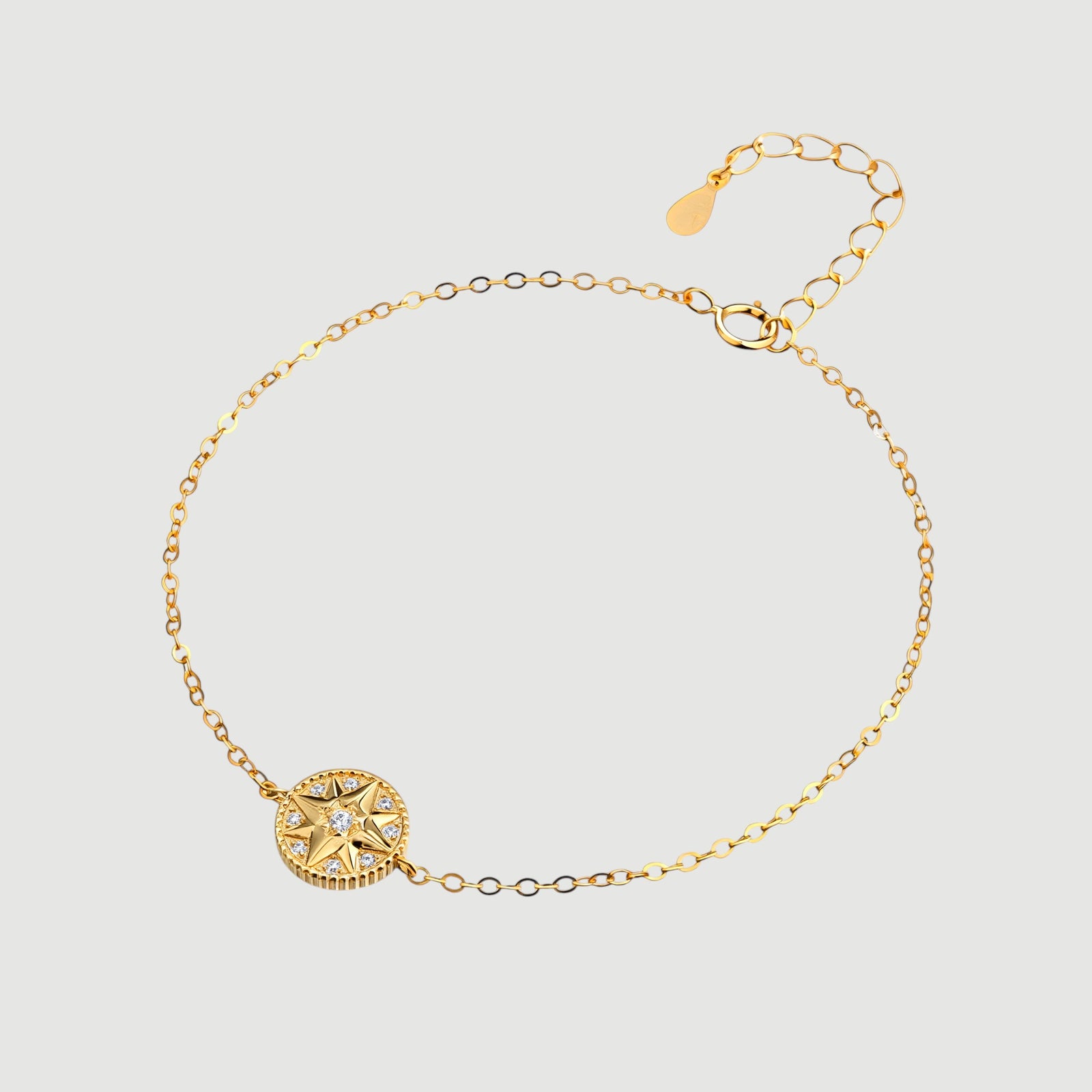 Amara Jewels gold-plated sterling silver bracelet with a celestial compass charm adorned with cubic zirconia. Adjustable chain.