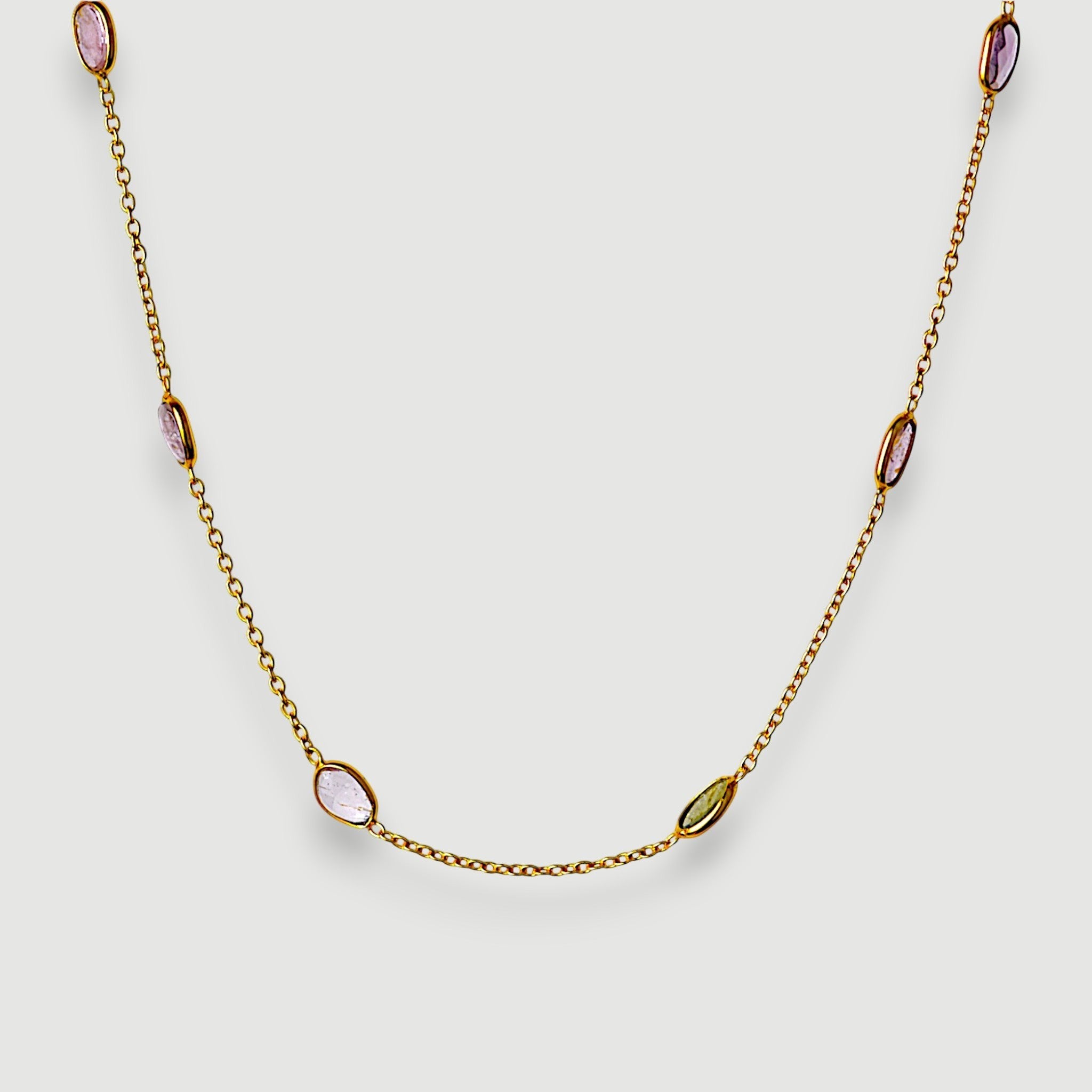 Amara Jewels 18K gold vermeil station necklace with bezel-set pastel amethyst, rose quartz, and green tourmaline.