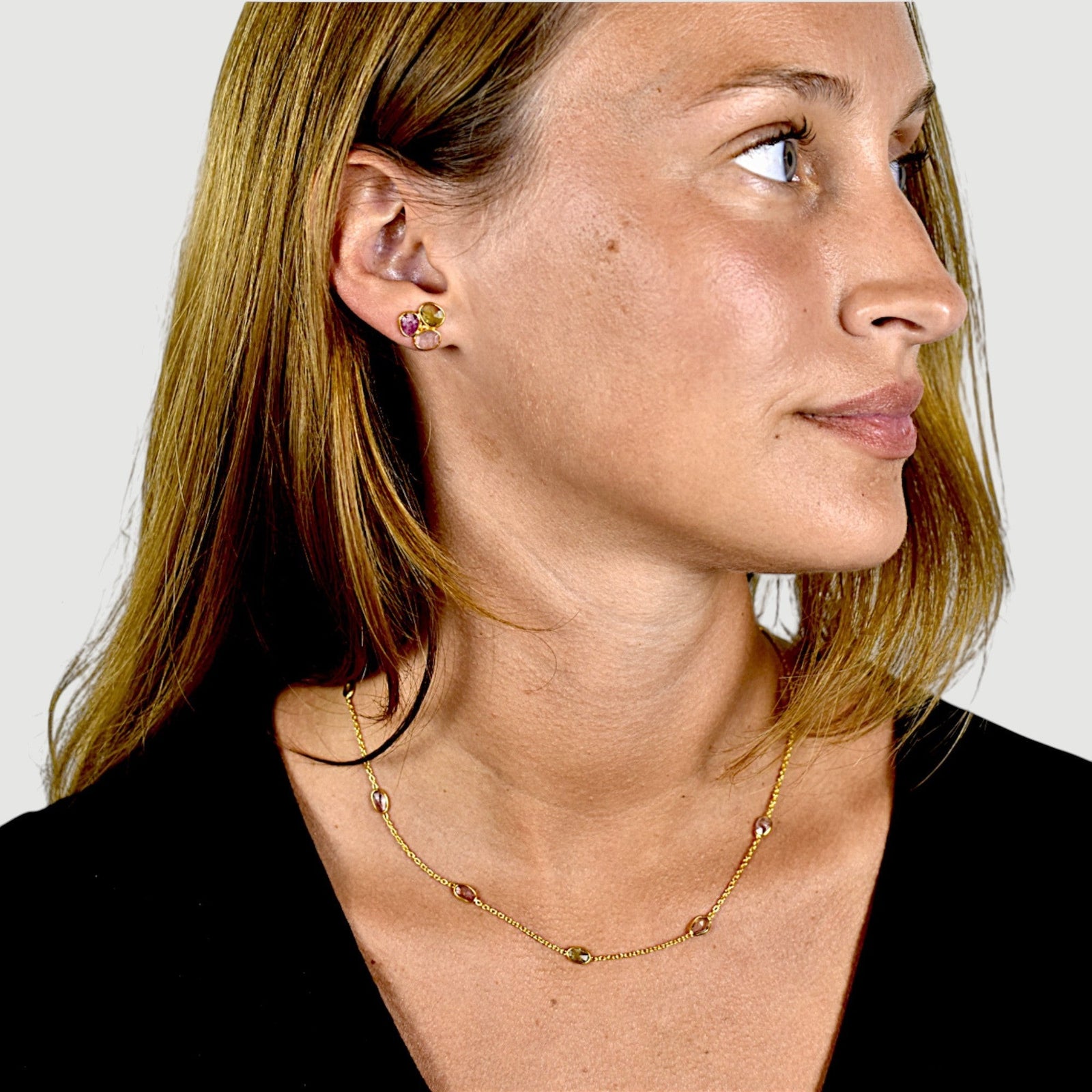 Amara Jewels 18K gold vermeil station necklace with bezel-set pastel amethyst, rose quartz, and green tourmaline.