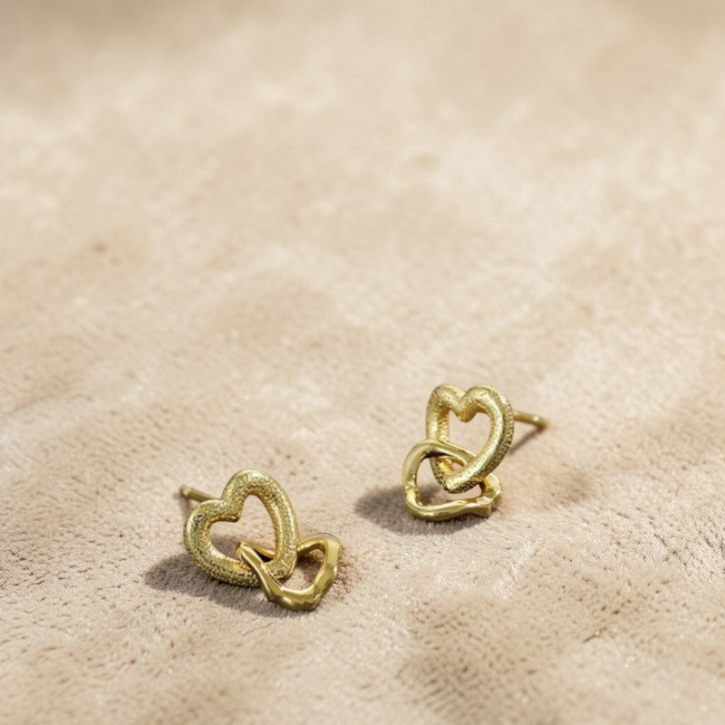 Amara Jewels gold-vermeil sterling silver interlocking heart earrings with textured and polished finishes.