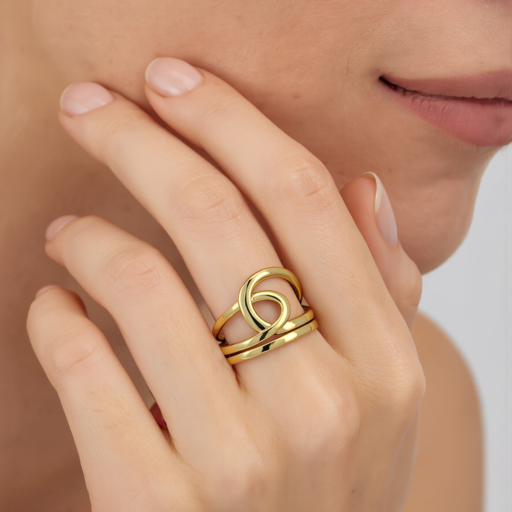 Amara Jewels gold-plated 925 sterling silver ring with an open knot design. Adjustable.