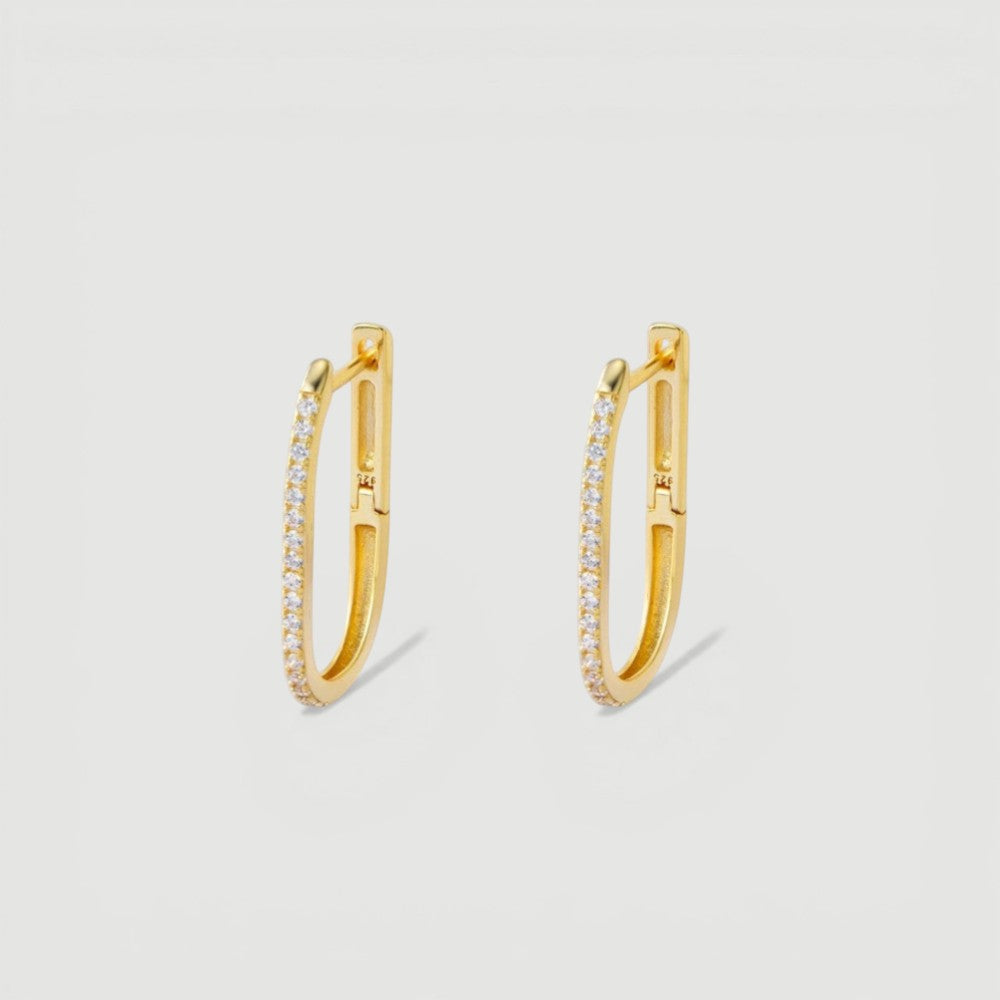 Amara Jewels gold-plated sterling silver oval hoop earrings with cubic zirconia accents.
