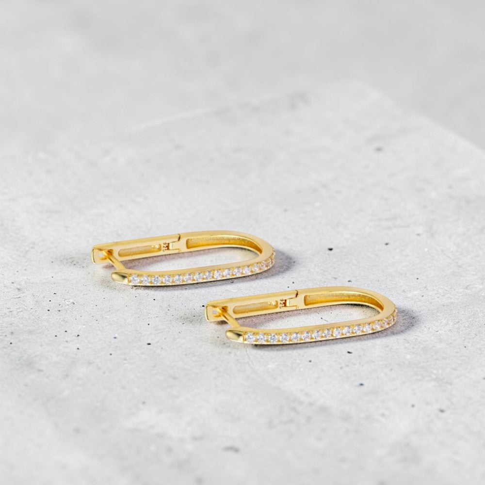 Amara Jewels gold-plated sterling silver oval hoop earrings with cubic zirconia accents.