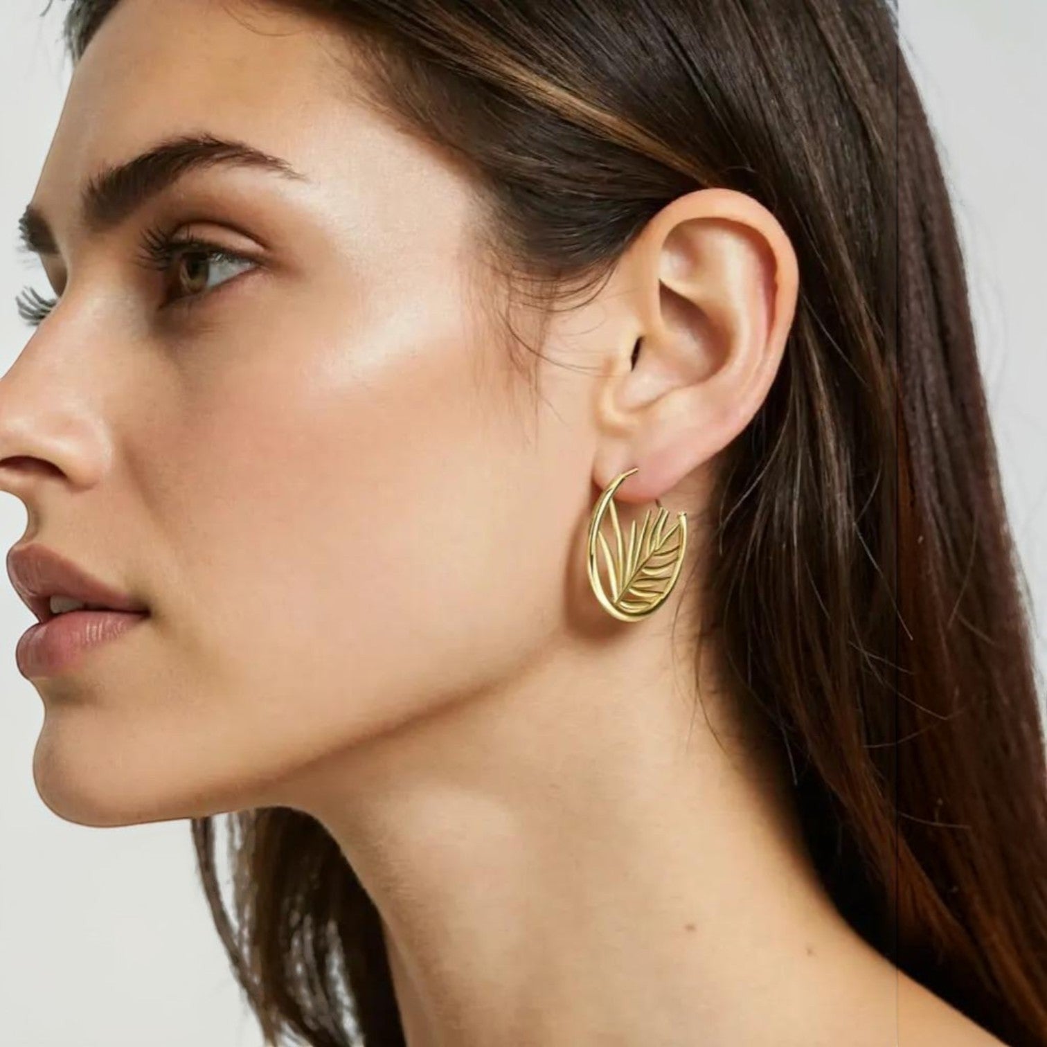 Amara Jewels gold-plated sterling silver hoop earrings with intricate palm leaf design. Elegant, nature-inspired statement jewelry.