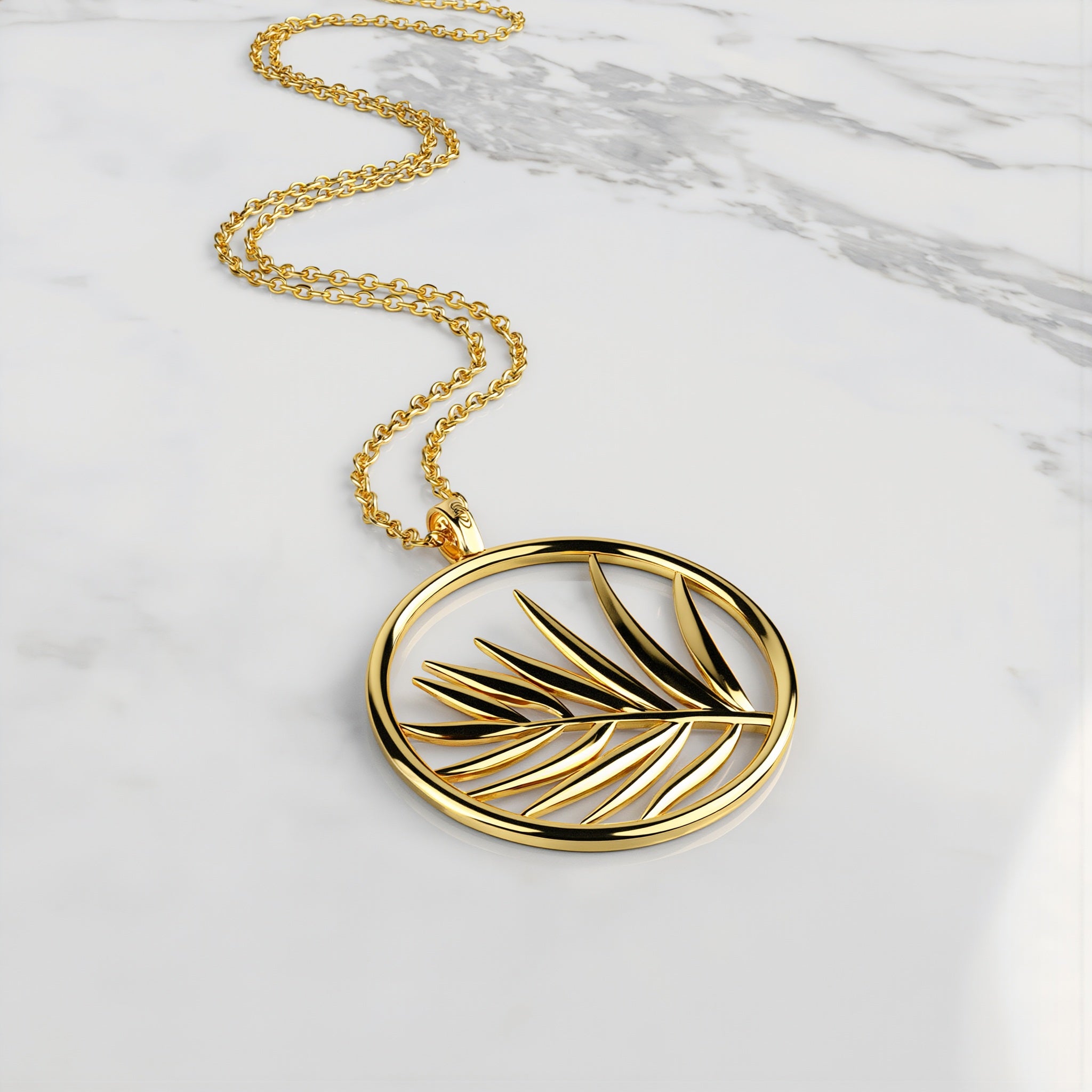 Amara Jewels gold plated sterling silver necklace with open circle palm leaf pendant.