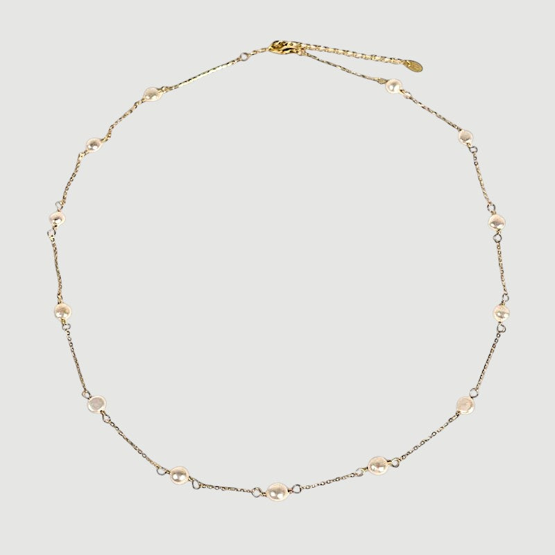 Amara Jewels 18K gold-plated sterling silver necklace with luminous pearl stations on a fine chain.