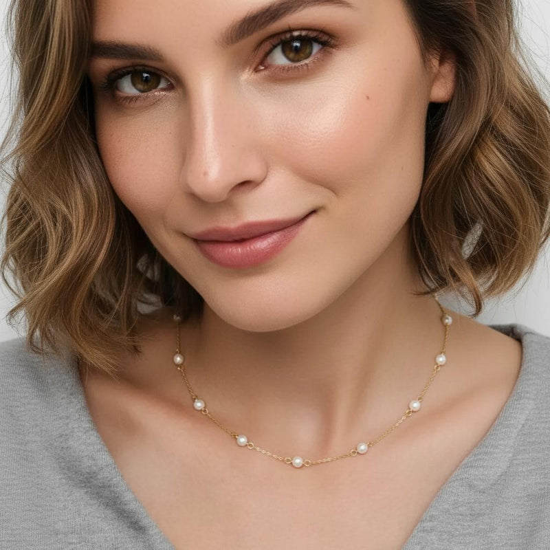 Amara Jewels 18K gold-plated sterling silver necklace with luminous pearl stations on a fine chain.