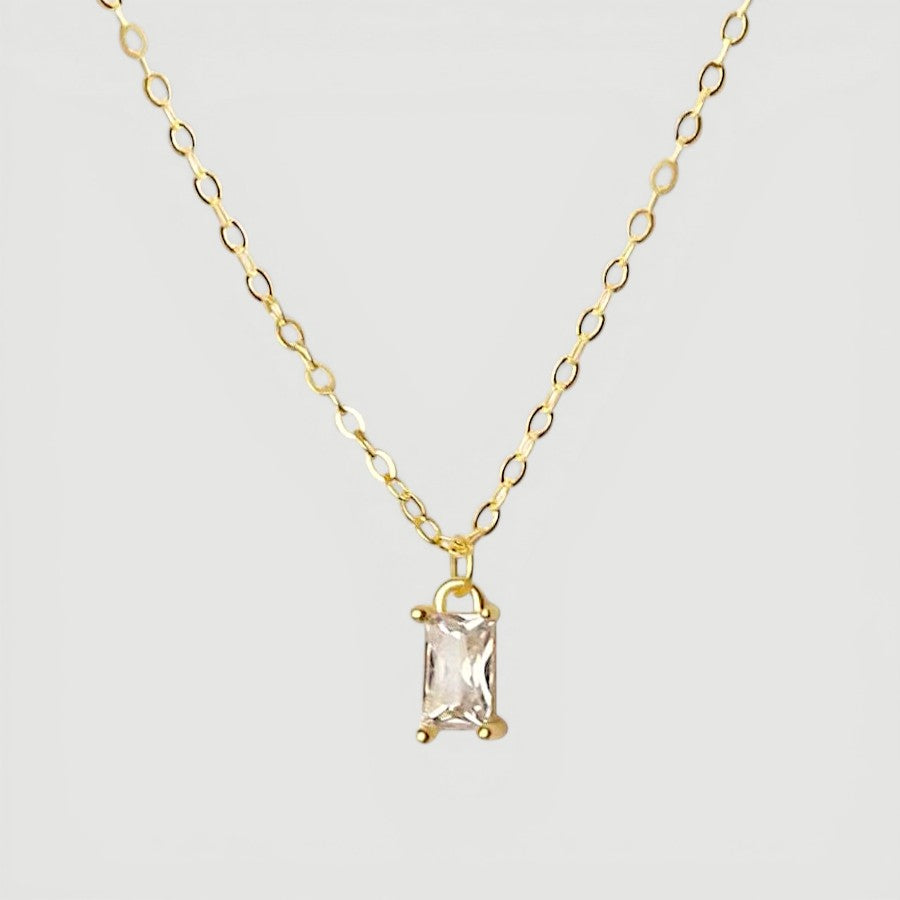 Amara Jewels gold-plated sterling silver necklace with a rectangular clear crystal pendant.
